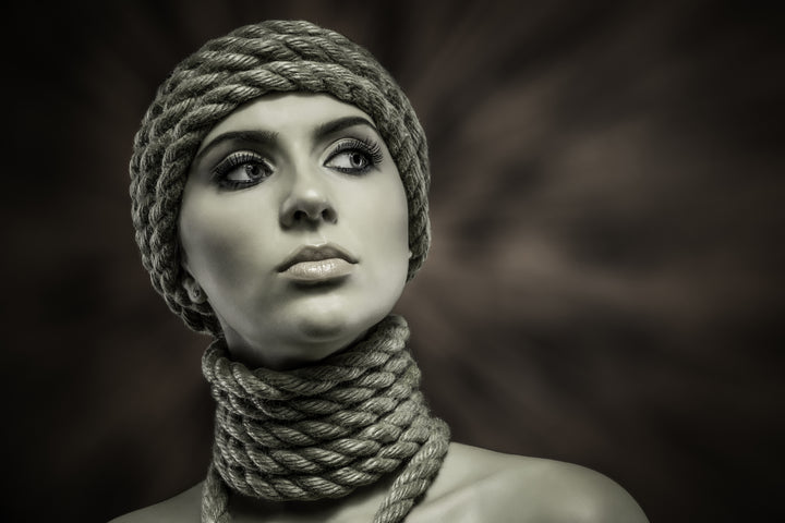 Knotty Desires Bondage Rope Tied Around Neck and Head on Beautiful Woman Wearing Makeup with Shoulders Exposed