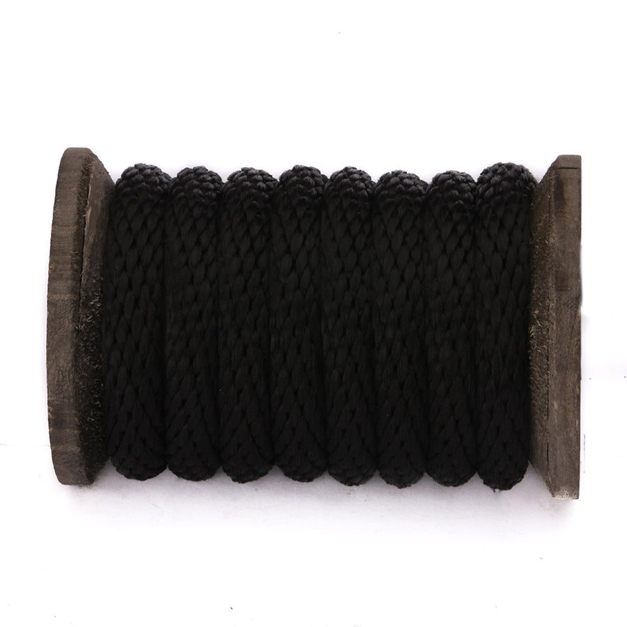 Knotty Desire black polypropylene bondage rope on a spool.