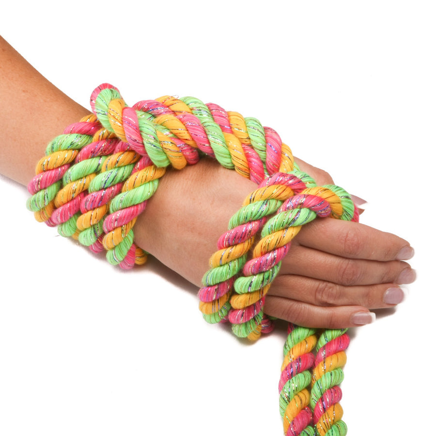 Knotty Desires tri-colored Twisted Cotton Bondage rope in pink glitter, gold, and lime knotted on a hand.