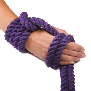 Knotty Desires Purple Twisted Cotton Bondage Rope tied on a hand. 