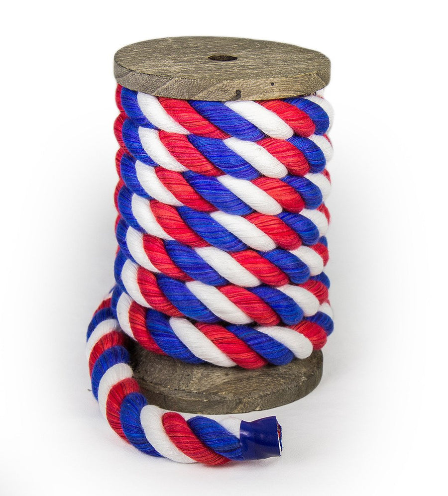 Red, White, and Blue Twisted Cotton Bondage Rope by Knotty Desires on a spool standing vertically.