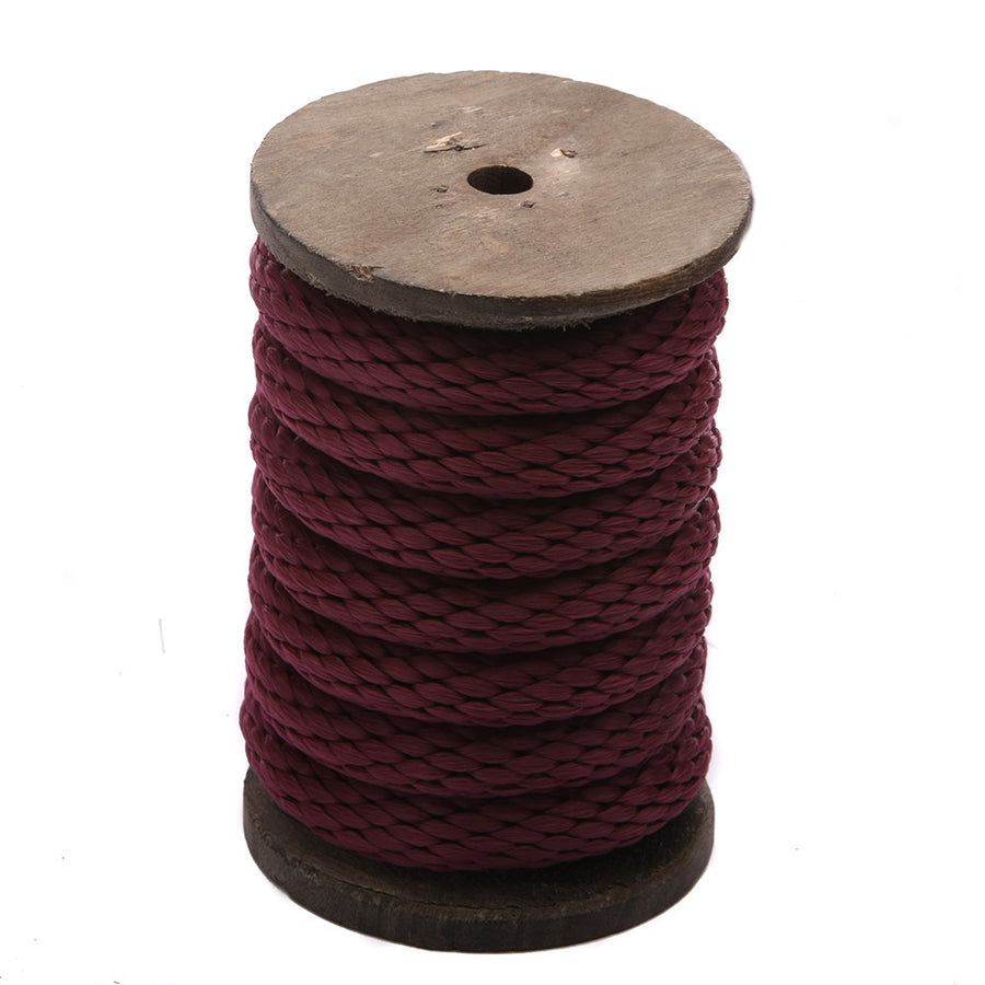 Knotty Desires burgundy polypropylene bondage rope on a vertical spool.