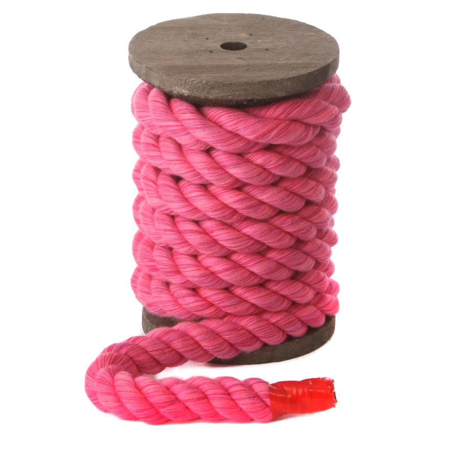 Knotty Desires Twisted Cotton Bondage Rope in hot pink on a spool standing vertically.